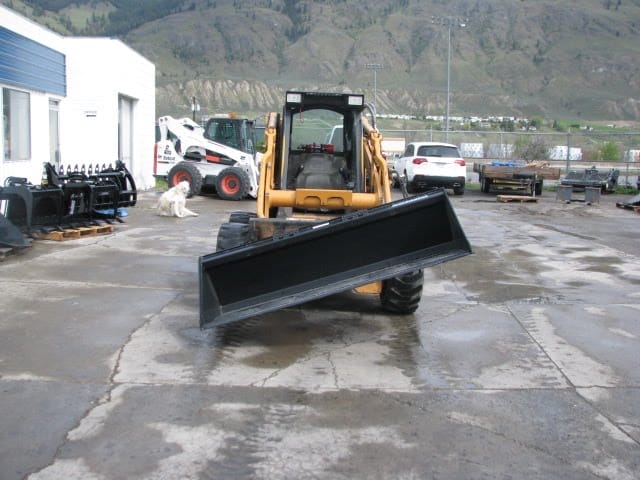 Skid steer dirt bucket on angle using tilt plate