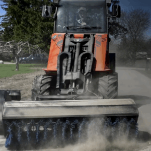 sweeper mounted on mini skid steer